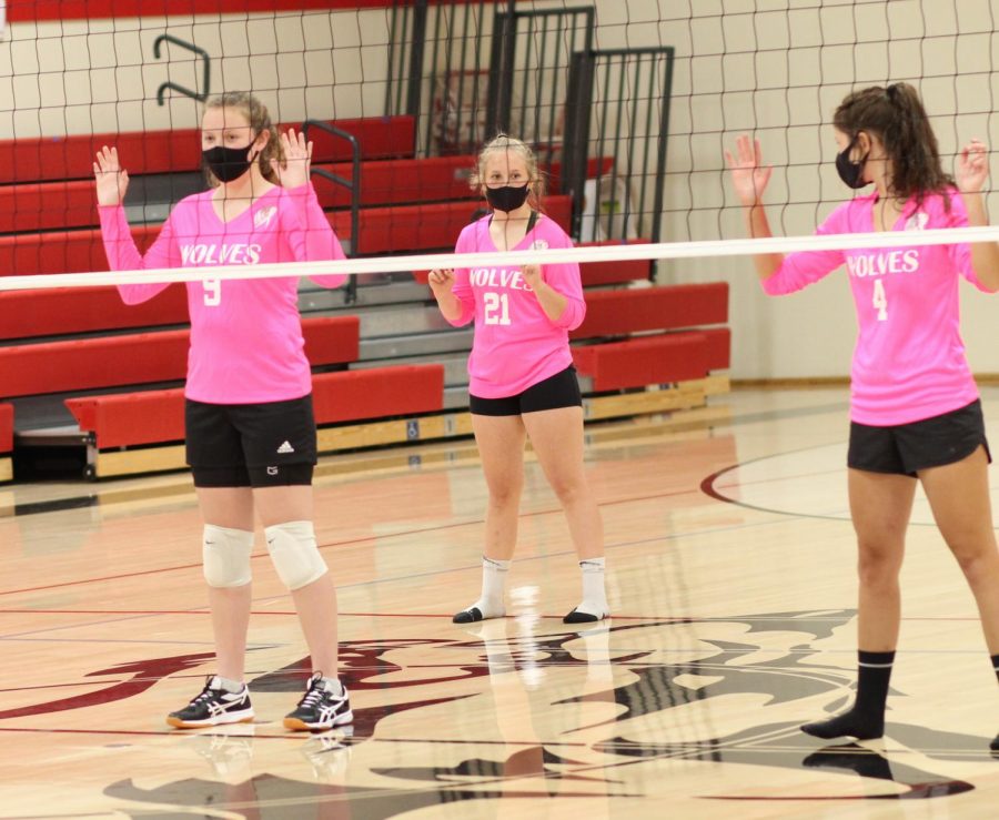 Volleyball players go through drills last September while wearing masks and maintaining a 6-foot distance.