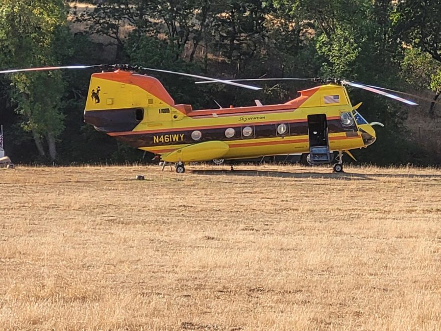 A helicopter rests at the helibase established off Days Creek Road. The helicopters dropping water and fire retardant onto nearby forest fires took off over Days Creek Charter School. 
