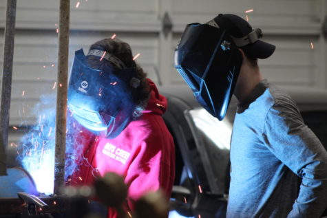 Shop students Kacey Benefiel, left, and Cordell Guckert weld during shop class Thursday afternoon.