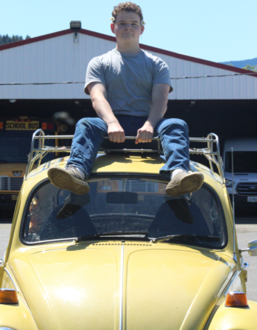 Logan Thompson sits atop his latest, and so far, most reliable vehicle, a Volkswagen Beetle.