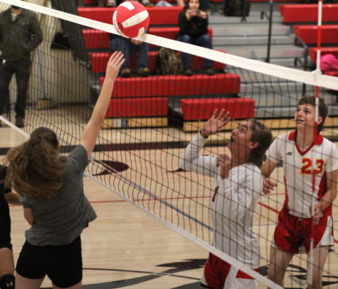 Gracie Stone tips the ball over the net during the annual Powder Tough volleyball game.