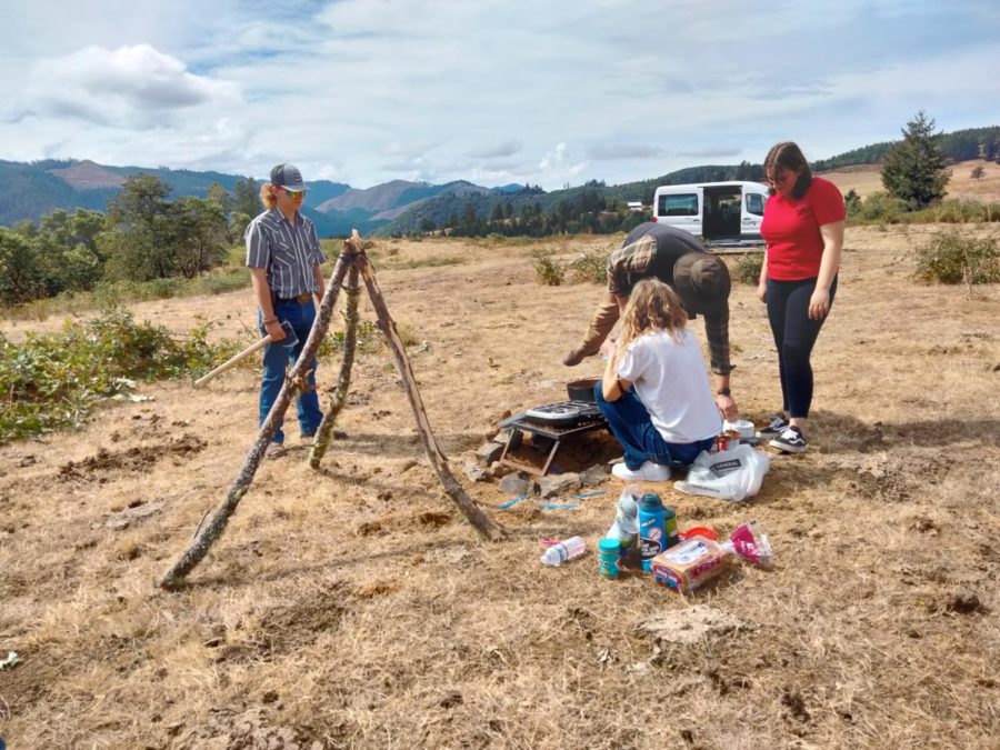 Former students Ian Harding, Madison Denson and Jayden Harder Quinn work with Mr. Giles at his property near Milo during homesteading class in 2023. This year's homesteading class also did a sleepover field trip at the same site as their final project.