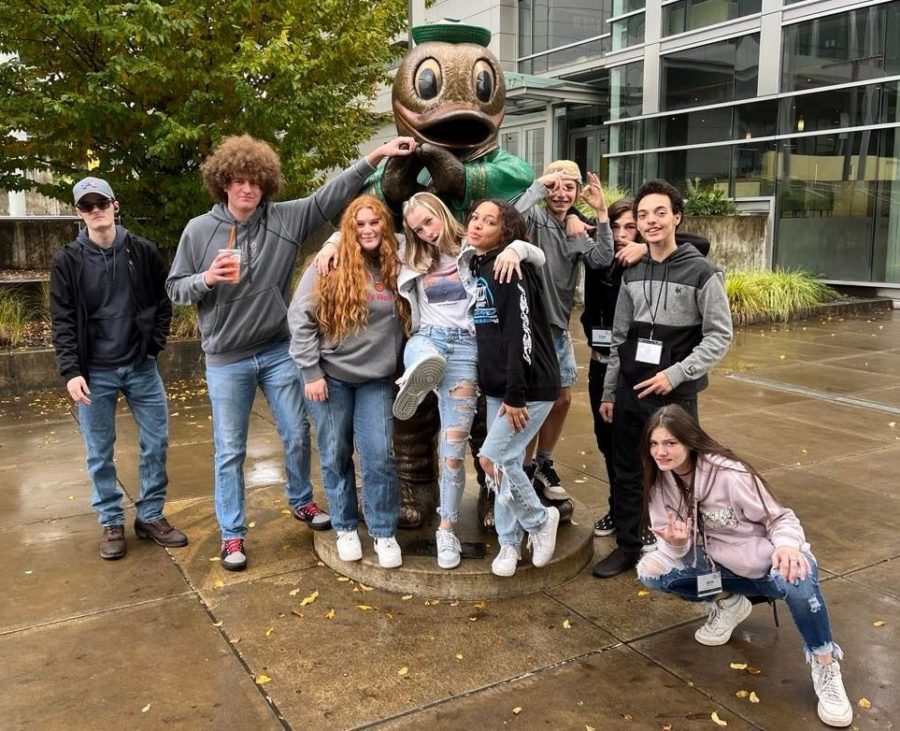 Days Creek journalism/yearbook students, from left, Cordell Guckert, Michael Jenks, Kaleigh Loiodici, Shayleigh Lynn, Lyris Berlingeri, Mason Peredetto, Evan Woodruff, Rossli Berlingeri and Mya Malone, pose on the campus of the University of Oregon after Fall Media Day on Wednesday.