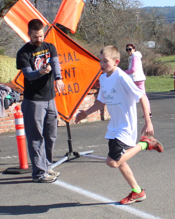 Boe McNeely sprints to the finish of the Shamrock Shuffle 5K Friday in Days Creek. The 6th grader won in 20:47.