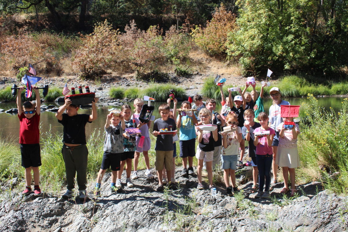 Second graders show off boats they built for the Boat Race Thursday on the South Umpqua River.