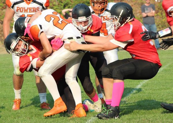 Days Creek players, from left, Keegan Stufflebeam, Ian Harding and Michael Peredetto tackle a Powers ballcarrier during a game in September. The Wolves host Glendale on Senior Night on Friday.