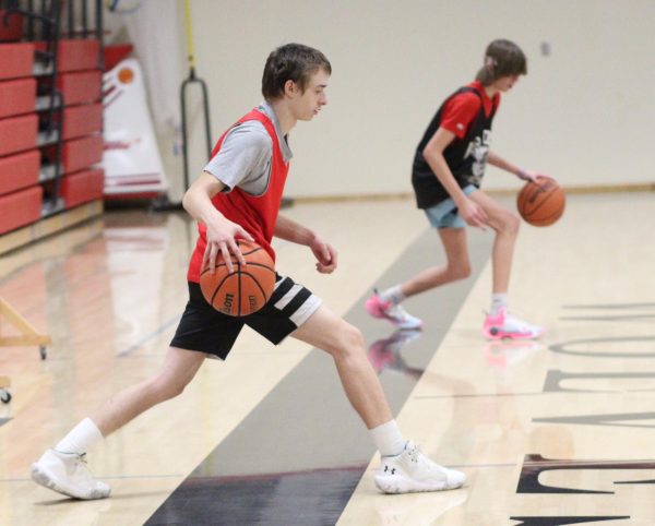Junior Aiden Denson and senior Marshall Haswell go through dribbling drills during a recent practice.