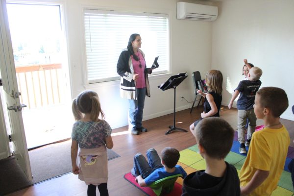 Music teacher Stephanie Angle instructs first grade students last month in the Little House now being used as a studio.