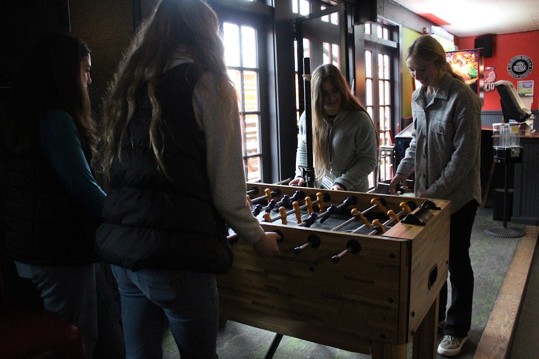 Days Creek journalism students play foosball at Pegasus Pizzeria during the lunch break of Fall Media Day, Dec. 2 at the University of Oregon in Eugene.