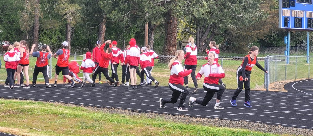 Members of the Days Creek track and field team warm up prior to the Maynard Mai Invitational in Glide this month. The Wolves have 30 athletes out for track this year.