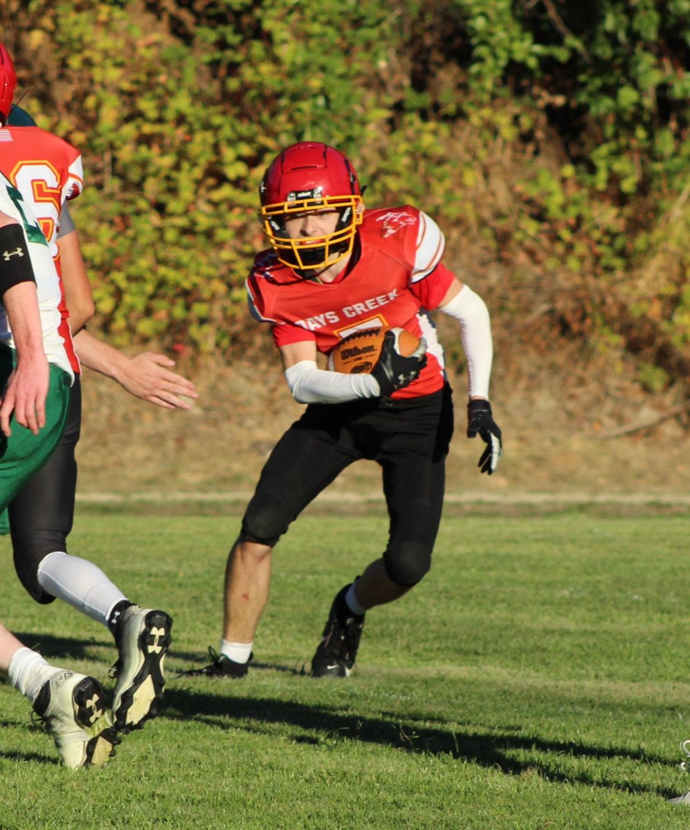 Senior Aiden Denson rushes against Gilchrist earlier this season.