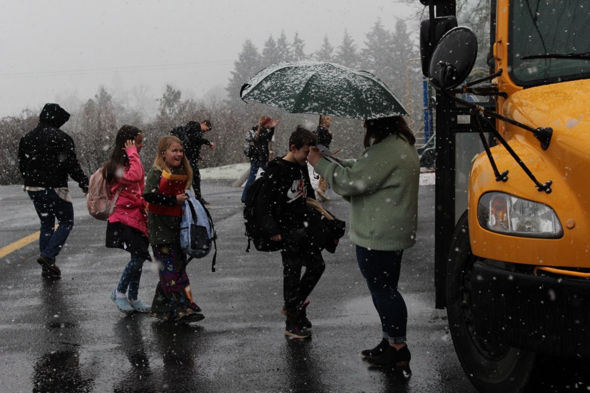 Students load onto the school bus after snow cancelled school on Feb. 3. School was cancelled the next two days, using all of the school's slack.