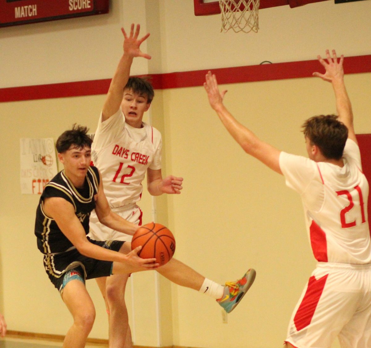 Daniel Brown (12) and Boone Stratford (21) defend an Echo player during Days Creek's first round playoff game last week. 