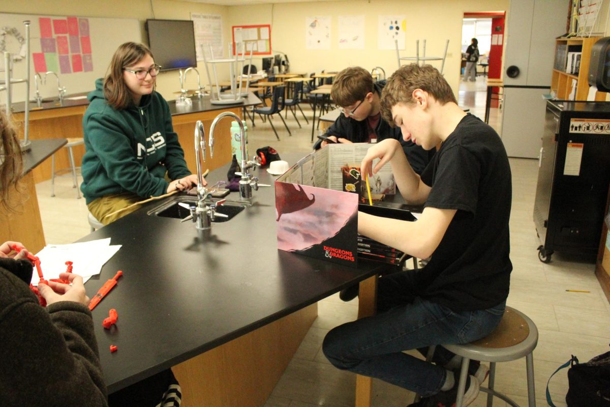 Senior Travis Doolittle, right, leads a Dungeons & Dragons activity during DiscoverU earlier this year as part of his senior project.