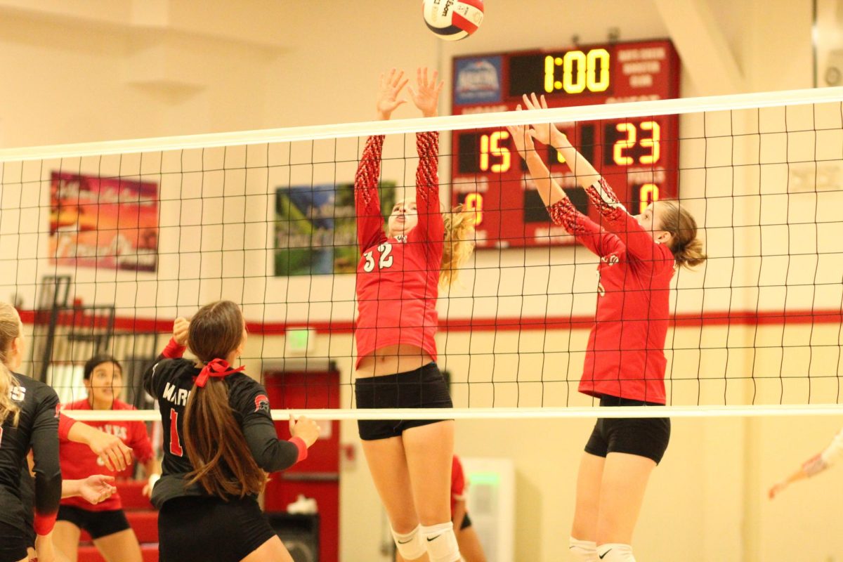 Ava Payne, left, and Maggie Brown attempt to block an attack during a game against New Hope last season. 