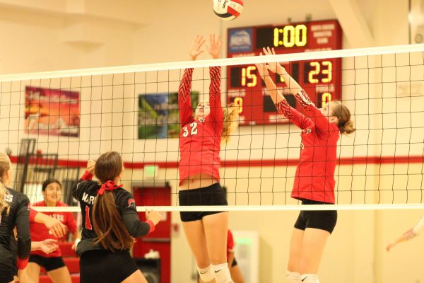 Ava Payne, left, and Maggie Brown attempt to block an attack during a game against New Hope last season. 