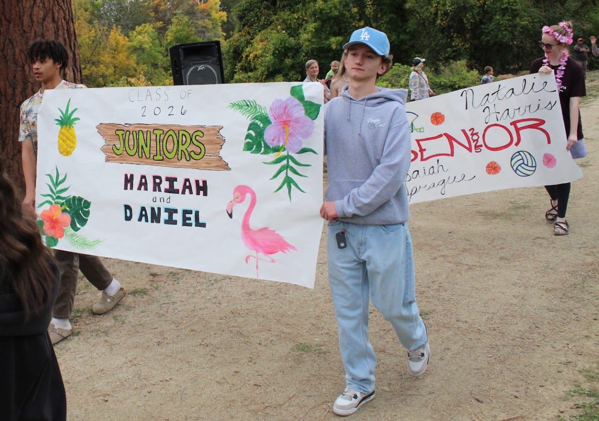 Xane Hopkins, left, and Jaron Cargill carry the class banner as juniors last years for homecoming. 