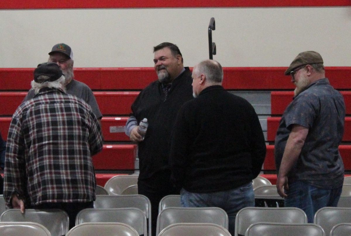 Daye Stone talks with community members after A Night to Shine Thursday in the Days Creek gym. Stone was named the district's new superintendent after final interviews, which were also conducted Thursday.